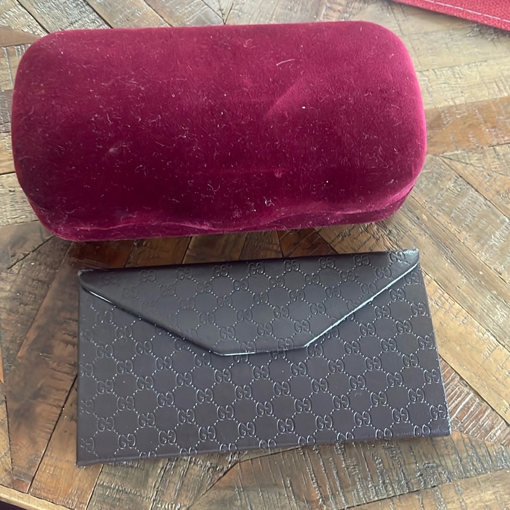 Two Gucci glasses cases